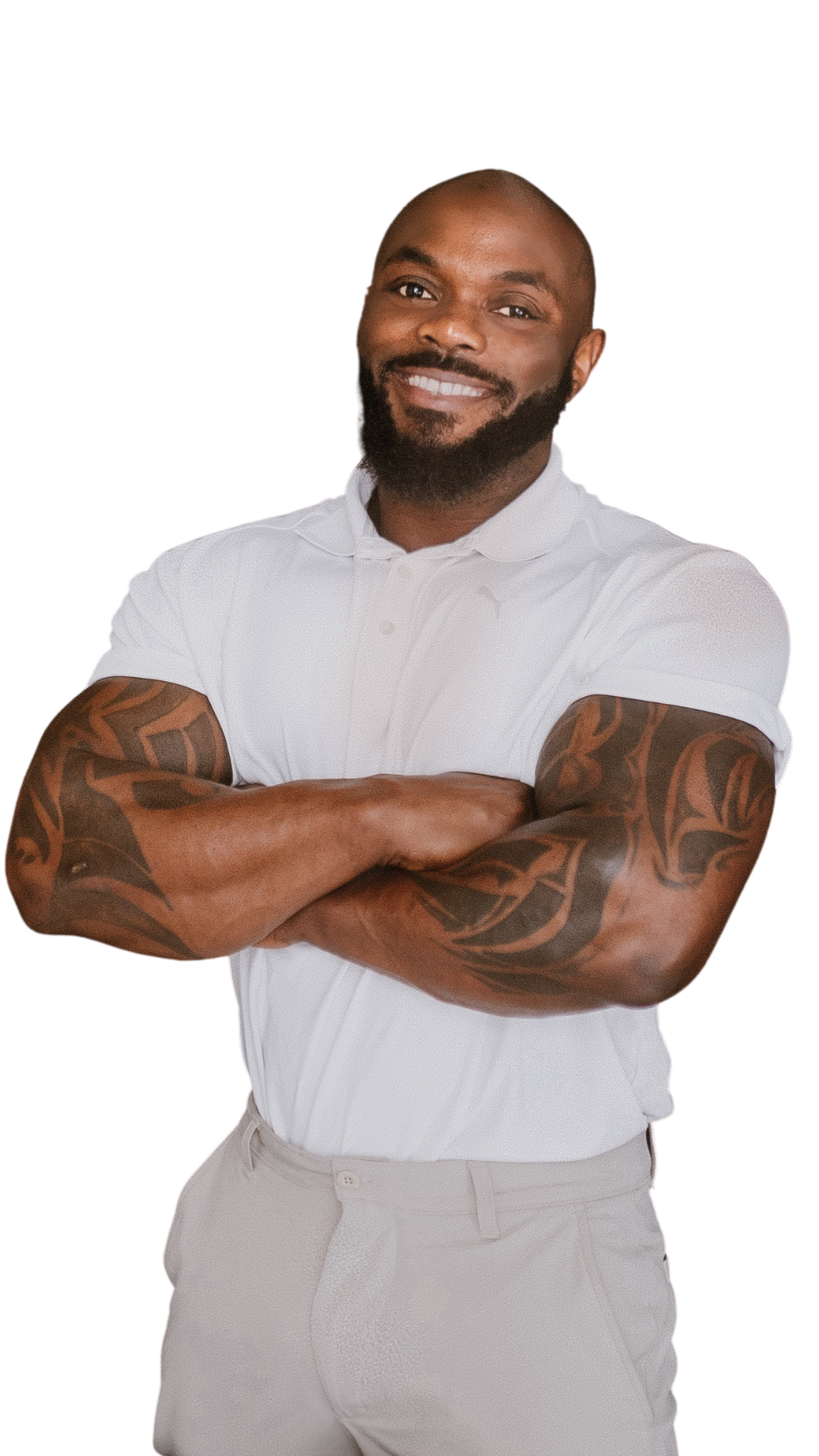 Therapist Daniel smiling with arms crossed, tattooed forearms, in a white polo shirt against a black background